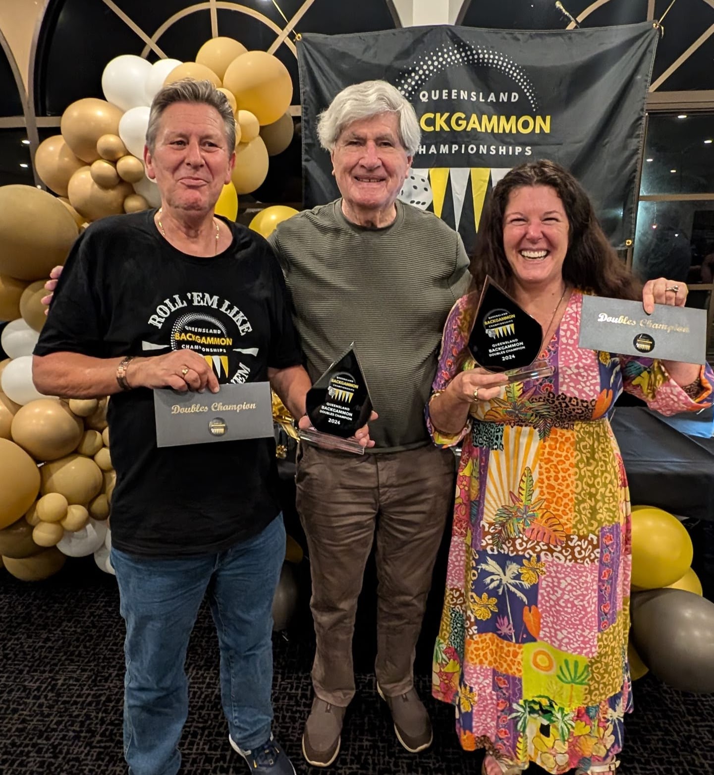 3 people, two of whom have been presented with trophies