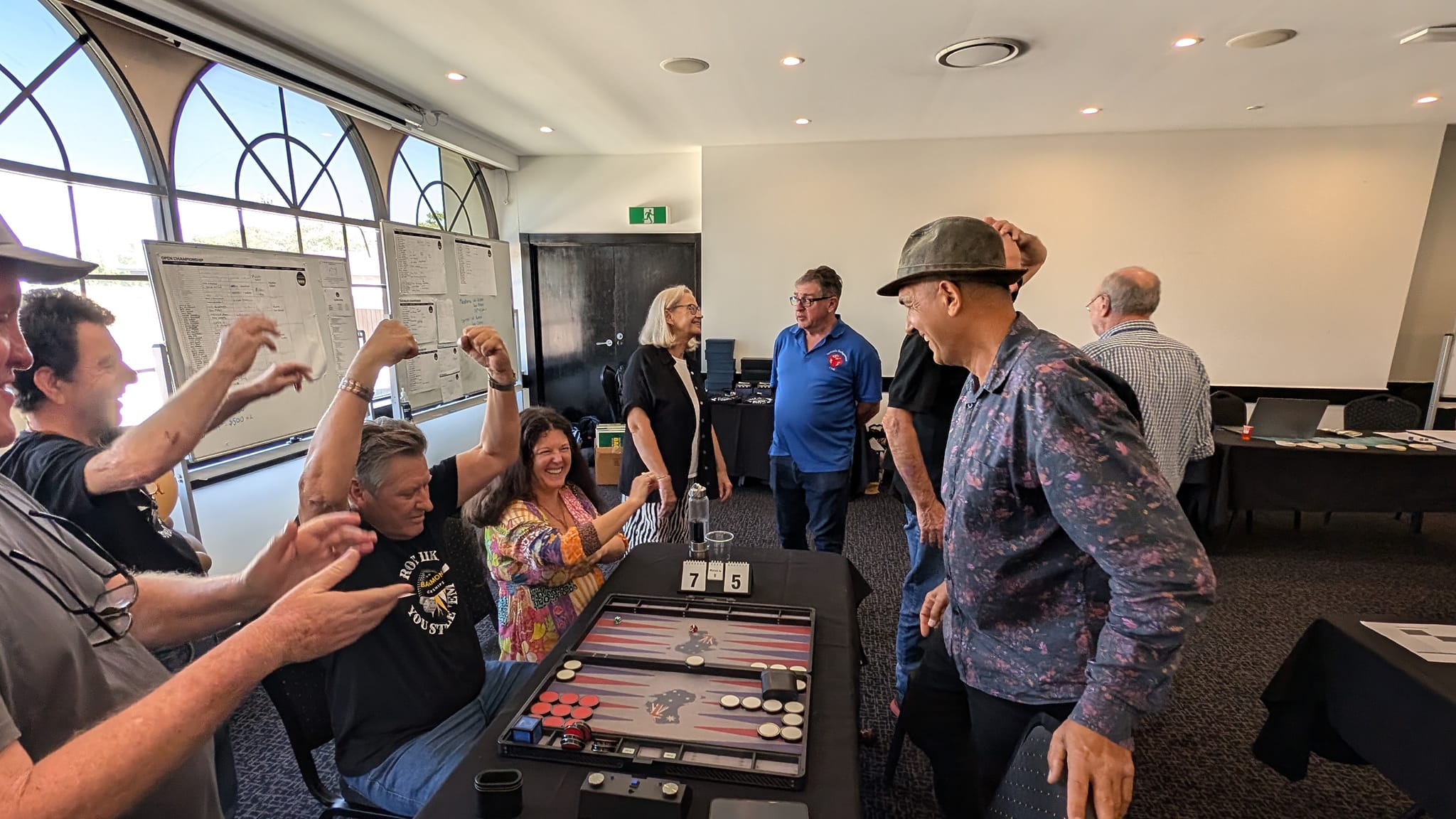 People cheering and celebrating after winning a backgammon tournament