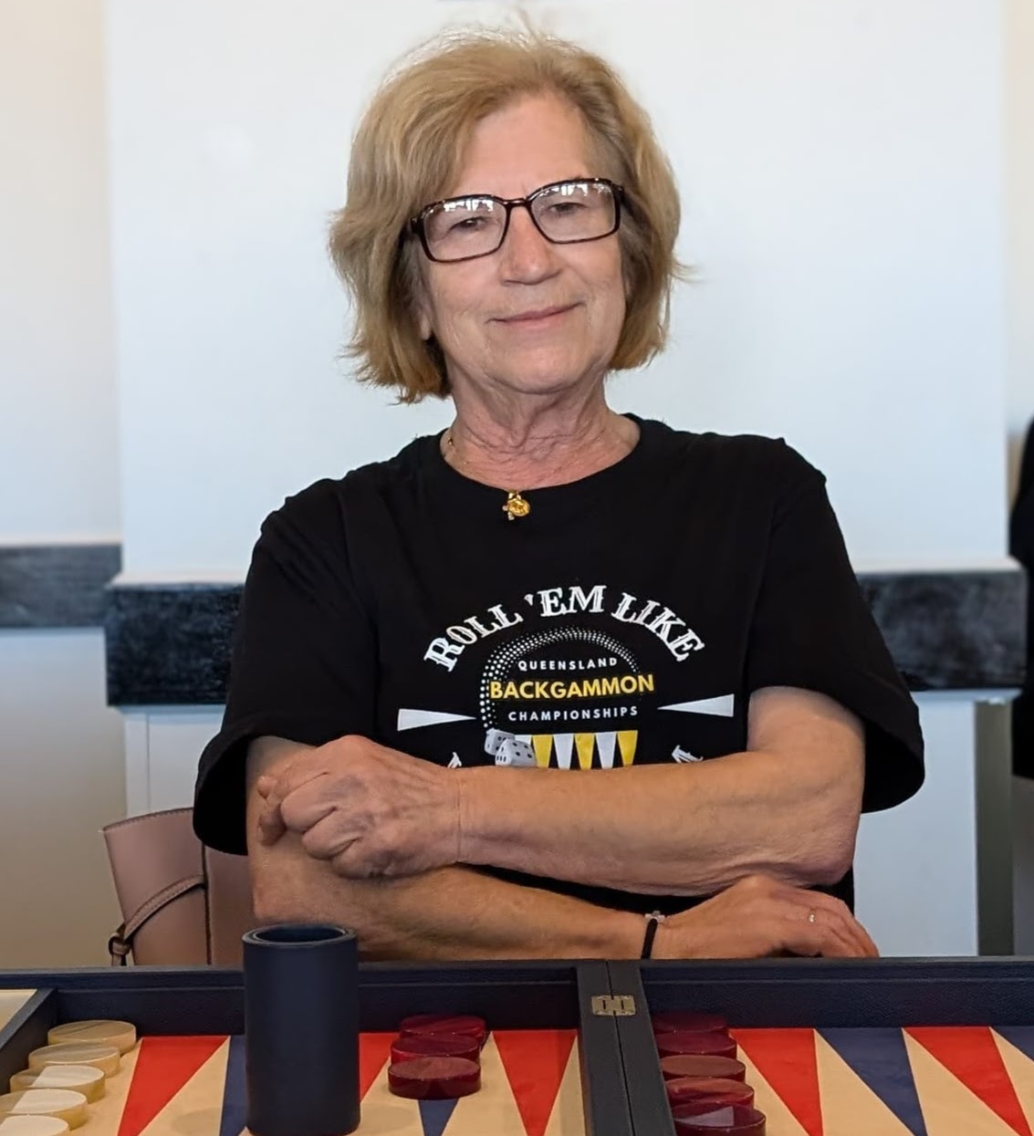 Dignified looking woman sitting in front of backgammon board