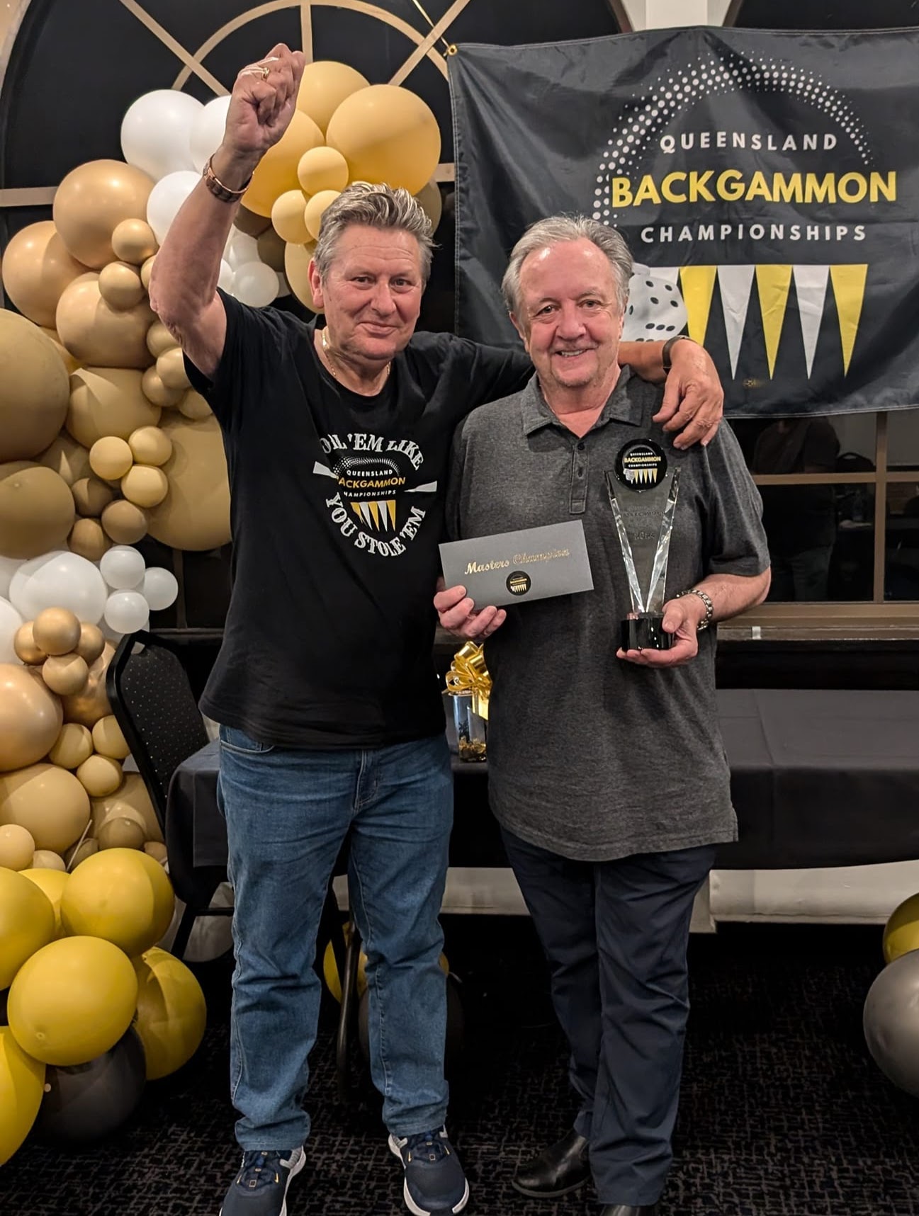 Man who has been presented with trophy and envelope