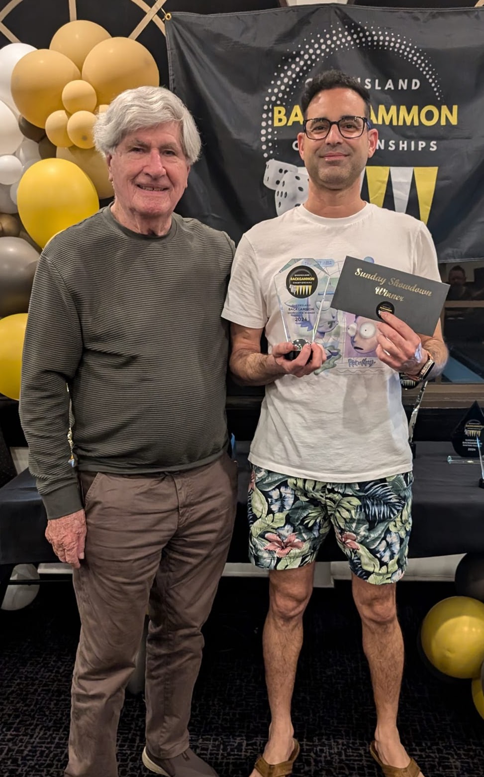 Man holding trophy and envelope